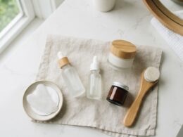 A minimal skincare product flat lay on a bright bathroom counter