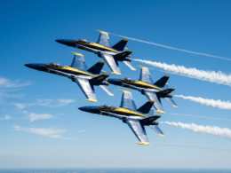 Blue Angels jets in tight formation during a flyover