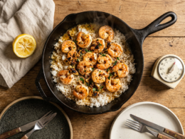 Easy 30 minute dinner recipes plated as garlic butter shrimp over rice in a skillet on a weeknight table