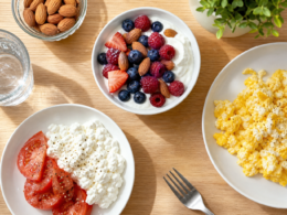 A high-protein breakfast spread with Greek yogurt and berries, scrambled eggs, and cottage cheese