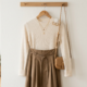 A stylish affordable outfit on a hanger with a few accessories