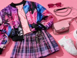 Bold K-pop street style flat lay with a colorful bomber jacket, plaid skirt, and chunky sneakers