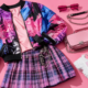 Bold K-pop street style flat lay with a colorful bomber jacket, plaid skirt, and chunky sneakers