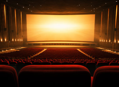 Empty premium large format movie theater auditorium with a bright illuminated screen