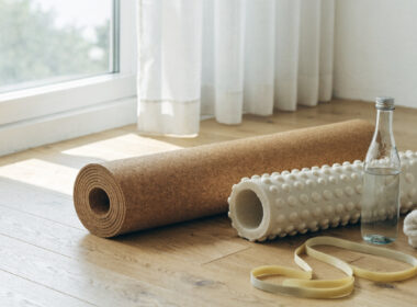 Recovery and mobility gear including a cork mat, foam roller, and resistance band in soft light