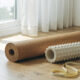 Recovery and mobility gear including a cork mat, foam roller, and resistance band in soft light
