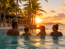 All inclusive resorts for families with parents and kids wading in a palm lined resort pool at golden hour