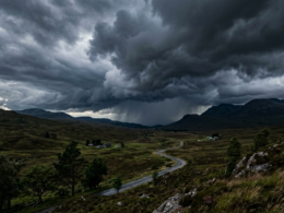A dramatic stormy sky with dark clouds over a landscape