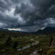 A dramatic stormy sky with dark clouds over a landscape