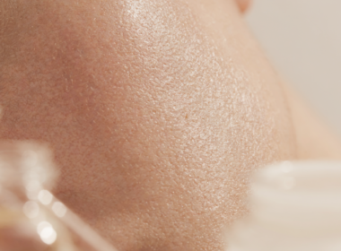 Close-up of luminous glowing skin with skincare products, illustrating a superhero skincare routine