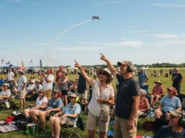 Spectators watching an air show as jets fly overhead