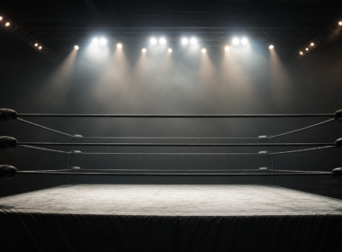 AEW Dynamite concept: an empty wrestling ring under dramatic arena spotlights