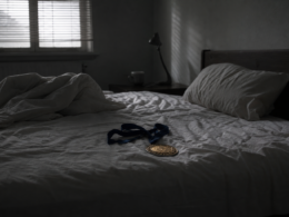 Big Brother 28 veto spoilers concept, gold medallion on a ribbon left on a rumpled bed at dawn
