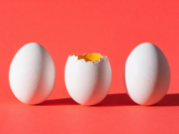Big Brother 28 veto ceremony concept, three white eggs on coral with the middle one cracked