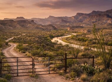 Big Bend National Park closures shown by a closed gate across a desert access road at golden hour