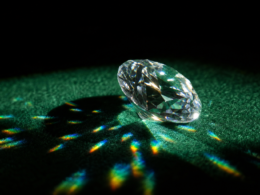 Big Brother 28 Diamond Power of Veto illustrated by a single cut diamond on dark green felt throwing refracted light