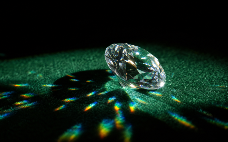 Big Brother 28 Diamond Power of Veto illustrated by a single cut diamond on dark green felt throwing refracted light