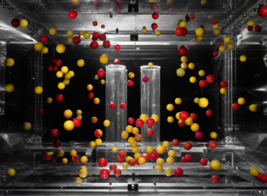 Big Brother 28 Space Race Block Buster shown by red and yellow spheres suspended mid air inside a clear acrylic chamber