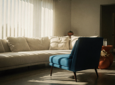 Big Brother 28 spoilers image of an empty accent chair in a sunlit living room with striped blind shadows