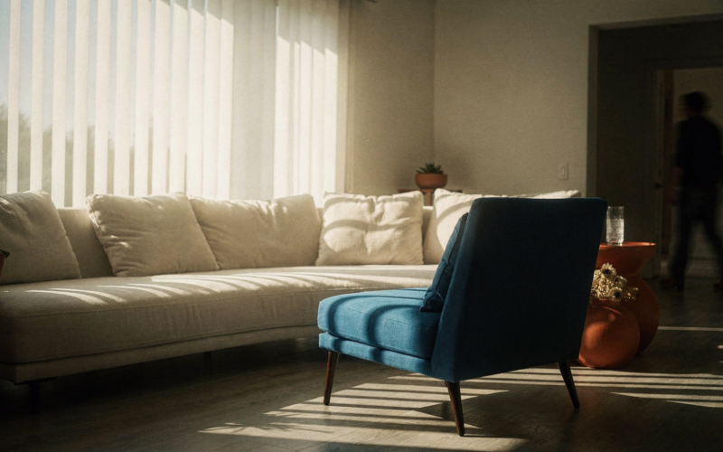 Big Brother 28 spoilers image of an empty accent chair in a sunlit living room with striped blind shadows