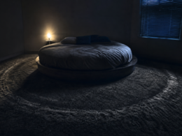 Big Brother 28 eviction spoilers shown by a dark empty bedroom with a round bed and a worn pacing path in the carpet
