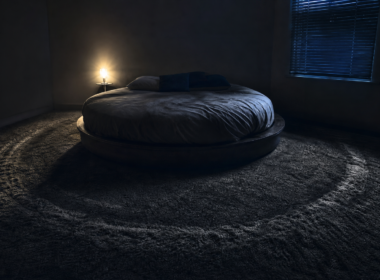 Big Brother 28 eviction spoilers shown by a dark empty bedroom with a round bed and a worn pacing path in the carpet