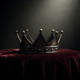 Big Brother 28 Week 6 HOH concept: a metal crown on dark velvet under a dramatic spotlight