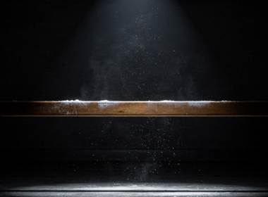 Big Brother 28 Week 7 HOH shown by a narrow wooden balance beam under a single spotlight in a dark room