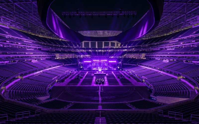 BTS AT&T Stadium concept: a giant stadium filled with purple concert lights at night