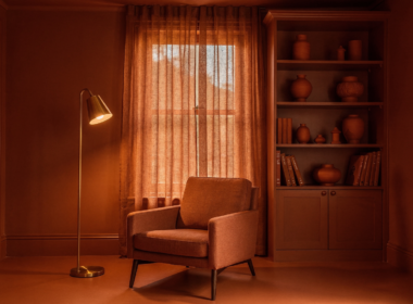 Color drenching in a home study with walls, trim, ceiling and shelving all painted the same terracotta tone