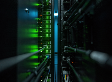 Cursor Origin launch during the GitHub outage shown as one lit server rack beside one that has gone dark