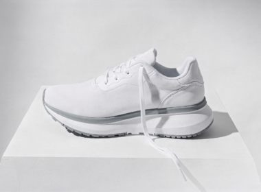 Dicks Sporting Goods stock drop, single white running shoe on white with one lace trailing loose