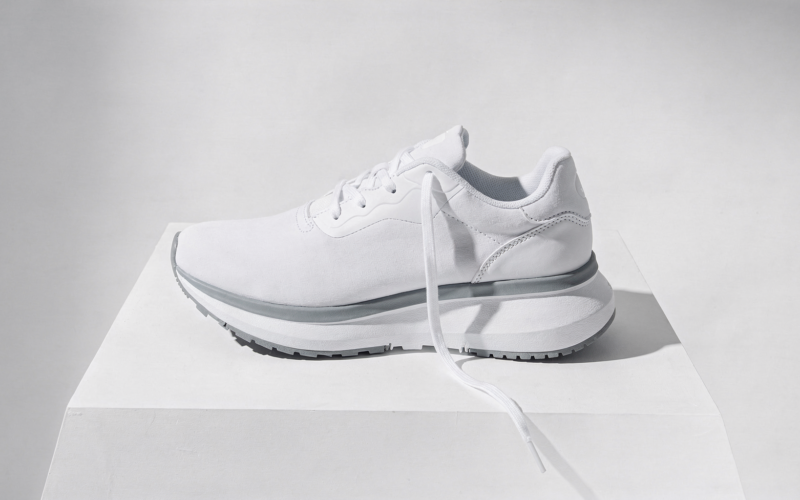Dicks Sporting Goods stock drop, single white running shoe on white with one lace trailing loose