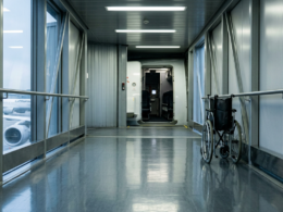 Wheelchair rule enforcement delay illustrated by a folded manual wheelchair parked beside an empty airport jet bridge doorway