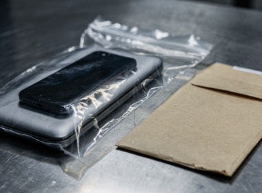 Eric Swalwell FBI devices seized, sealed evidence bag holding a phone and laptop
