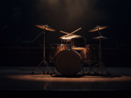 Tribute to Frank Beard of ZZ Top shown as an empty vintage drum kit under a single spotlight on a darkened stage