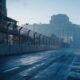 Freedom 250 Grand Prix shown by concrete race barriers and catch fencing along an empty city avenue at dawn