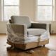 A half unwrapped armchair in cardboard and plastic in an empty room as furniture prices shift after ordering