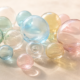 Hugging Face sale concept, cluster of translucent pastel glass spheres in soft daylight