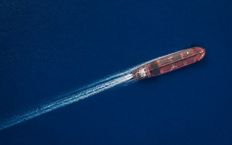 Iran sanctions markets concept, aerial view of a single oil tanker on deep blue open ocean