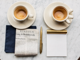Jeffries Kushner meeting concept, overhead flat lay of two espresso cups on white marble