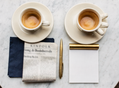 Jeffries Kushner meeting concept, overhead flat lay of two espresso cups on white marble