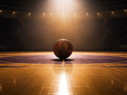 Lakers sale concept: a basketball at center court under a spotlight in a dark arena