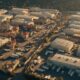 Paramount Warner Bros merger concept, aerial view of two adjacent studio backlots at golden hour