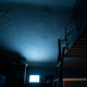 Meta child addiction trial, dark bedroom ceiling lit cold blue from an unseen screen below