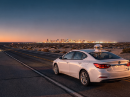 Nevada robotaxi permits concept, desert highway at dusk with a sensor equipped sedan