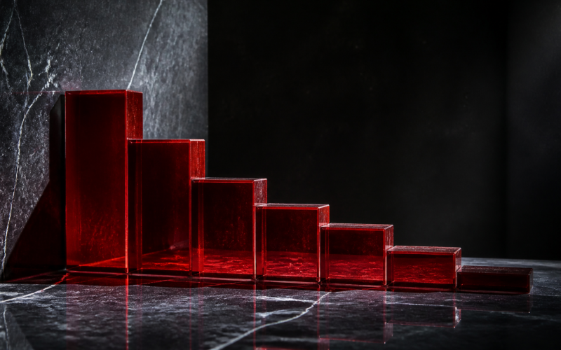 Nike stock decline shown as a descending row of red glass blocks on dark polished stone