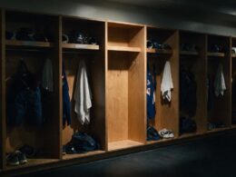 Peyton Watson trade illustrated by a dim locker room with one stall stripped bare among a full row of gear