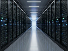 Long data center aisle lined with server racks receding into the distance