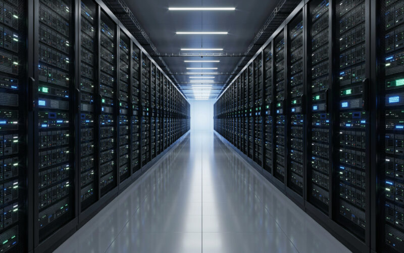 Long data center aisle lined with server racks receding into the distance